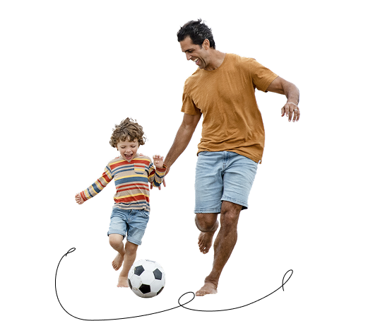 Dad and son playing soccer